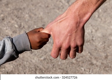 A Refugee child on Hand of a Helper
