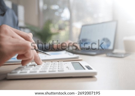 refund, pending, payment, processing, finance, Person reviewing payment transaction and refund status using calculator and laptop, representing finance management, processing, and digital billing.