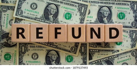 Refund symbol. Concept word 'refund' on wooden cubes on a beautiful background from dollar bills. Business and refund concept. - Shutterstock ID 1879137493