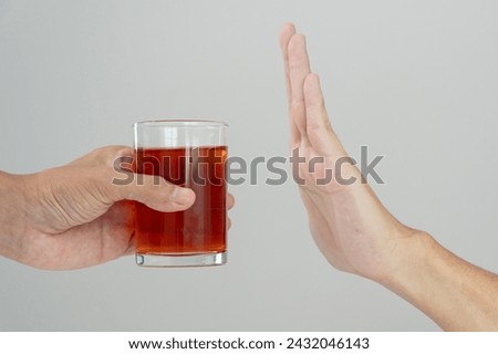 refuses say no and avoid to drink an alcohol whiskey , stopping hand sign male, alcoholism treatment, alcohol addiction, quit booze, Stop Drinking Alcohol. Refuse Glass liquor, unhealthy, reject