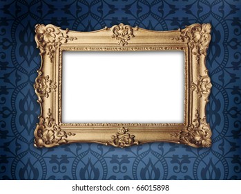 Regency Or Victorian Style Gold Frame Hanging On Decorative Blue Patterned Wallpaper