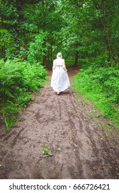 Regency Woman Wearing Coat Walking Along A Woodland Path