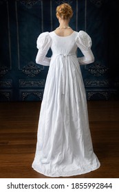 A Regency woman in a white muslin dress alone in a room