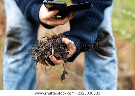 regenerative organic farmer, taking soil samples and looking at plant growth in a farm. practicing sustainable agriculture	

 Foto stock © 