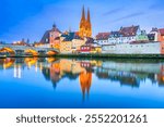 Regensburg, Germany. Historical downtown and the Gothic cathedral, Danube River water reflection in Bavaria.