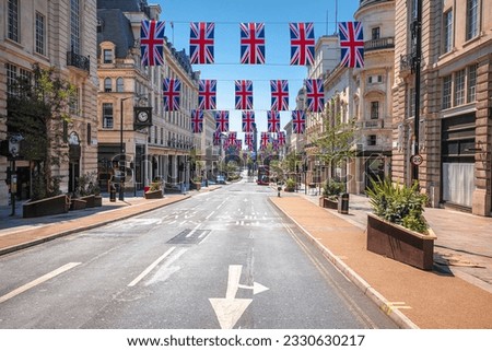 Regent Street Saint James in London scenic street view with UK flags, capital of United Kingdom