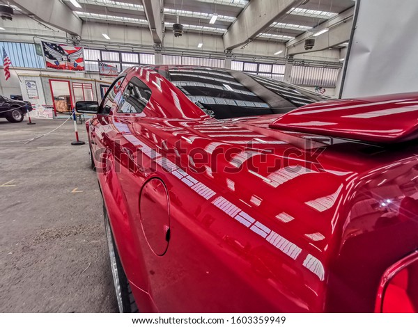 Reggio Emilia / Italy - December 14 2019 :\
Free Cars Show Event with japanase and classical americans muscle\
cars - new red black mustang\
ford