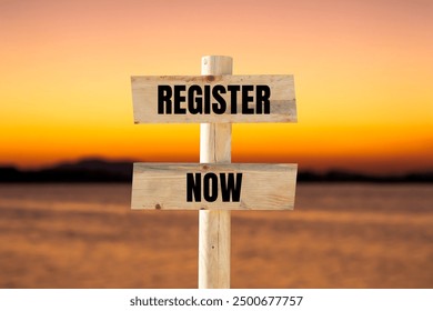 Register now message written on wooden sign with blurry lake background. Conceptual register now symbol. Copy space.