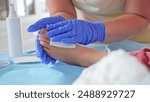 Registered Nurse Pediatritian Surgeon Doctor Treating Feet Injury Wound during Medical Procedure on Young Caucasian Girl Patient