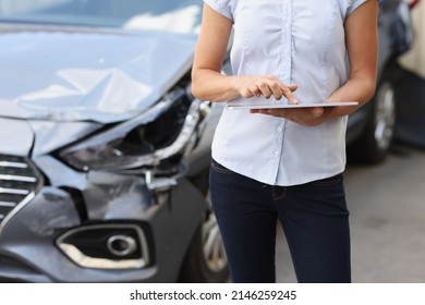 Registration of damage to car after accident. Car insurance and cash compensation concept - Shutterstock ID 2146259245