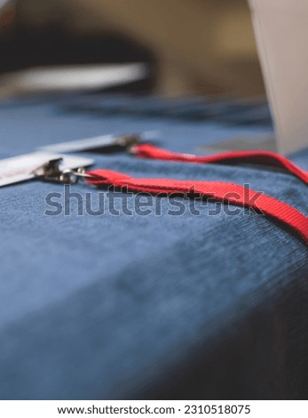 Registration desk table, process of checking in on a conference congress forum event, visitors and attendees receiving a name badge and entrance wristband bracelet and register electronic ticket
