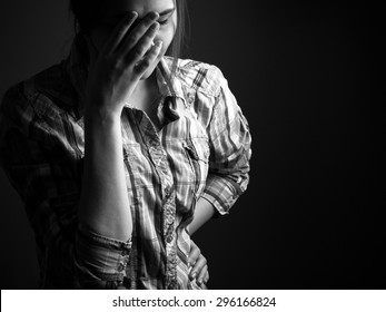 Regret, Guilt And Sadness. Portrait Of A Girl In The Studio. Black And White