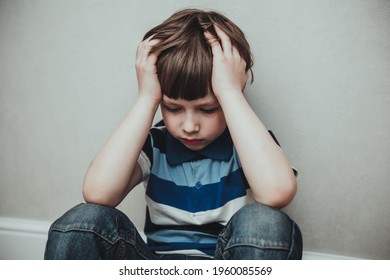 Regret Sad Little Boy Sitting Alone Loneliness,stressed Depressed Child Crying Having Depression, Anxiety, Trouble Of Mental Health, Lonely Kid Boy With Hands On Head, Hikikomori Syndrome Disease