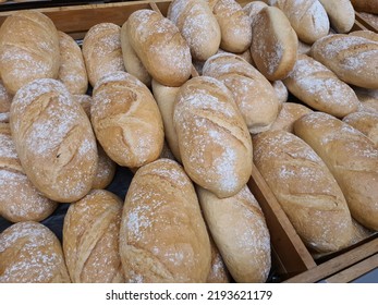 Regular bread loafs in bakery in bakery or grocery store. Freshly baked in shopping display, close-up - Shutterstock ID 2193621179