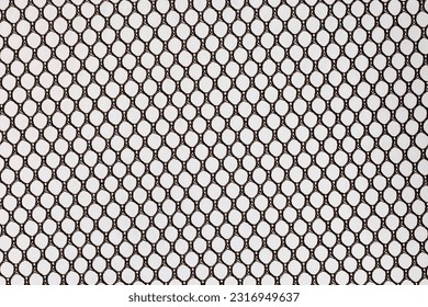 Regular cells of black mesh fabric isolated on grey background
