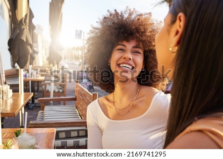 Regular dates for catching up should be a trend. Shot of two friends catching up while having drinks at a bar outside.
