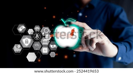  regularly checking and preventing data breaches within the organization, eavesdropping to steal secrets, a businessman picks up an apple to look at the worms that have eaten inside of a surveillance