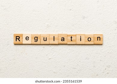 regulation word written on wood block. regulation text on table, concept. - Powered by Shutterstock