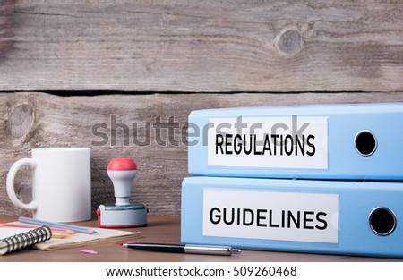 Regulations and Guidelines. Two binders on desk in the office. Business background