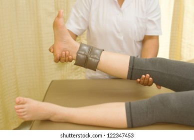 Rehab muscle training for leg with physical therapist - Powered by Shutterstock