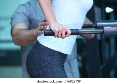 Rehabilitation concept. Young woman doing exercises under physiotherapist supervision