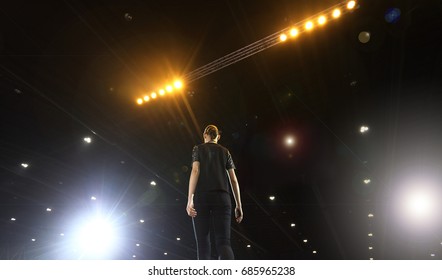 Rehearsal Of Finale Session From Professional Woman Models On Ramp Stage With Full Scale Lighting On Ceiling, Shoot From Behind No Face, Low Exposure