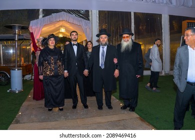 Rehovot, Israel - 11.01.2019. Parents And Rabbi Leading Jewish Groom To Chuppah In Jewish Chasid Wedding With Happy Guests