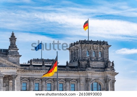 The Reichstag building with the German and EU flags flying. Flags flying on the Reichstag building.