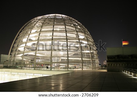 reichstag dome and german flag at night, berlin, germany