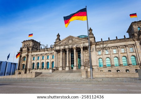 Reichstag facade view with German flags in Berlin, Germany