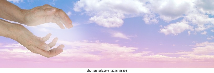 Reiki Healer Sending Healing With The Power Of Intention - Female Cupped And Gentle Healing White Light Against A Beautiful Wide Blue Pink Cloudscape And Space For Messages