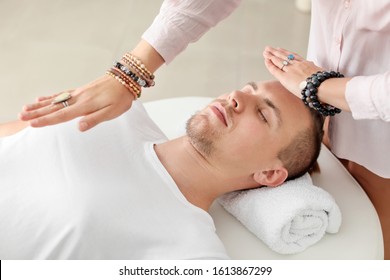 Reiki master working with patient - Powered by Shutterstock