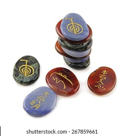 Reiki Meditation Stones - Three Sets Of Reiki Symbols Etched In Gold Onto Semi-precious Carnelian, Agate And Aventurine Oval Flat Stones On A White Background