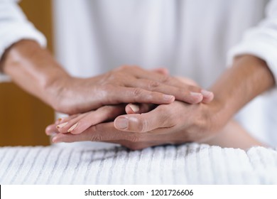 Reiki Practitioner And Patient Holding Hands At Reiki Session. Energy Healing Concept.