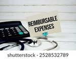 Reimbursable Expenses text message on paper card with stethoscope and calculator on wooden background