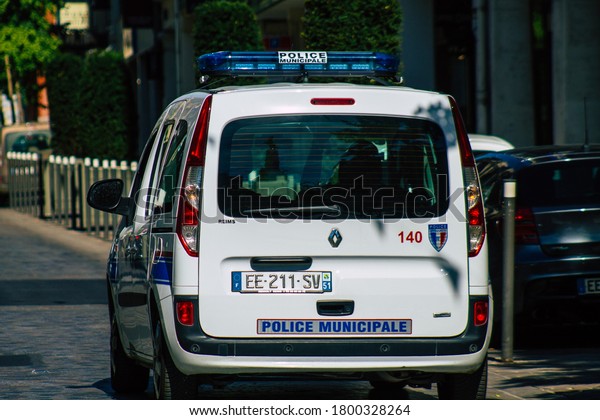Reims France August 06, 2020 View of a traditional\
French police car driving through the historical streets of Reims,\
a city in the Grand Est region of France and one of the oldest in\
Europe