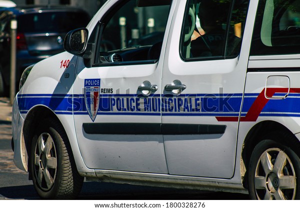 Reims France August 06, 2020 View of a traditional\
French police car driving through the historical streets of Reims,\
a city in the Grand Est region of France and one of the oldest in\
Europe