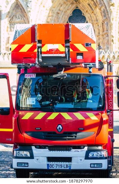 Reims France December 18, 2020 View of a red\
French fire engine in intervention in front of the Reims cathedral\
during the coronavirus pandemic affecting France and the lock down\
of the country