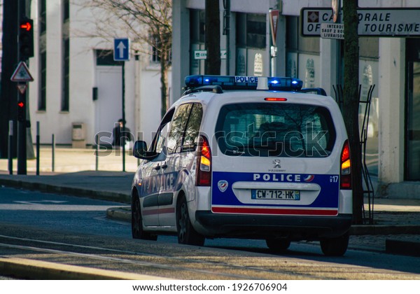Reims France February 24, 2021 French\
police car in the streets of Reims during coronavirus pandemic and\
the lockdown to impose containment of the\
population