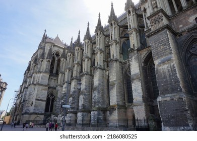 Reims, France - June 2022 - The impressive North side and transept of the medieval Notre-Dame Cathedral, on Guillaume de Machault Street ; the facade is supported with massive flying buttresses