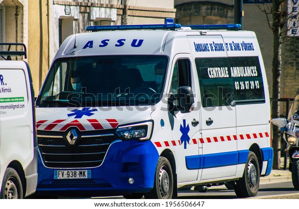 Reims France March 31, 2021 Ambulance driving\
through the streets of Reims during the coronavirus pandemic\
affecting France