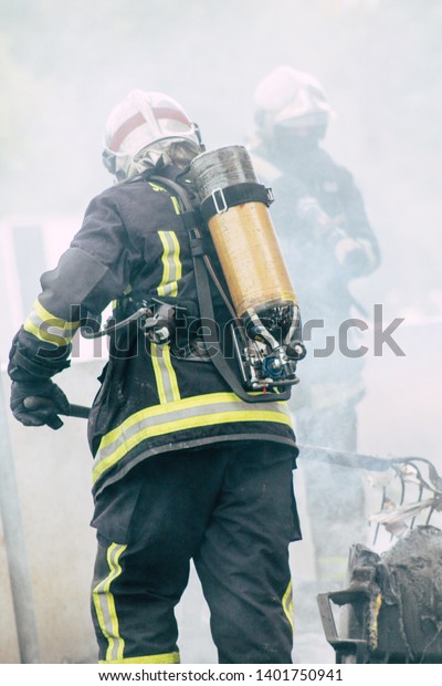 Reims France May 18, 2019 View of firefighters\
extinguishing a construction hut burned by rioters during protests\
of the Yellow Jackets in the streets of Reims on saturday\
afternoon
