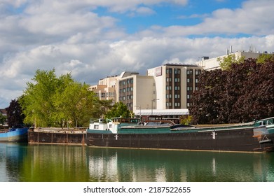 Reims, France - May 2021 - River boats moored along the docks of Paul Doumer Boulevard, at the marina of the Vieux-Port (Old Port), on the Aisne to Marne Canal, a waterway crossing Champagne-Ardenne