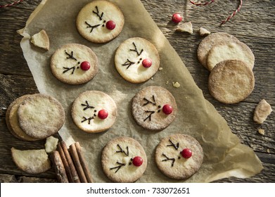 Reindeer cookies with candy red nose on a baking paper. Christmas concept.