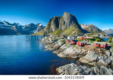 Reine, Lofoten, Norway - 04/06/2017:  The village of Reine under a sunny, blue sky, with the typical red rorbu houses. Stock photo © 