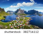 Reine, Lofoten, Norway. The village of Reine under a sunny, blue sky, with the typical rorbu houses. View from the top