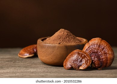 Reishi Mushroom (Lingzhi) Powder In Wooden Bowl.