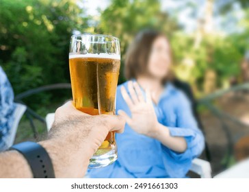 Reject a glass of beer, woman refusing alcohol, stop drinking, sobriety concept, saying no to beer glass, alcohol decline, rejecting, refuse with hand gesture - Powered by Shutterstock