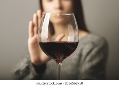 reject liquor,stop alcohol, teenager girl shows a sign of refusal of wine - Shutterstock ID 2036562758