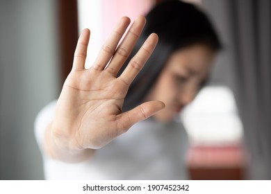 rejecting woman saying stop, no, halt with hand gesture - Shutterstock ID 1907452342